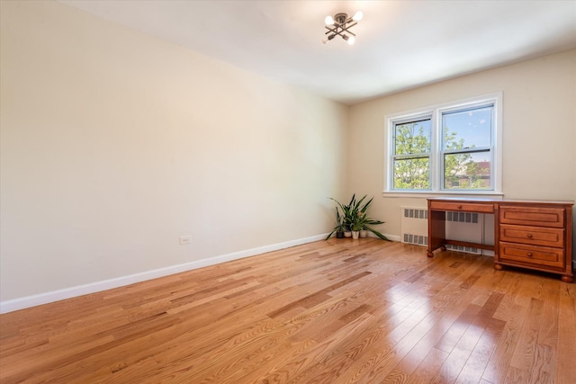 150-20 77th Ave, Kew Garden Hills, NY 11367 - unfurnished room featuring baseboards, radiator heating unit, and light wood-style flooring