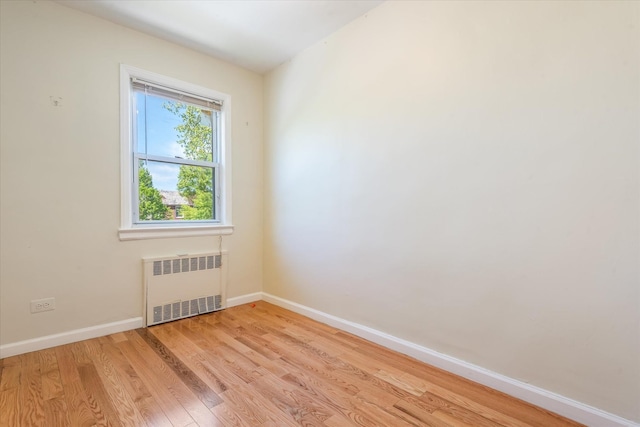 150-20 77th Ave, Kew Garden Hills, NY 11367 - empty room featuring light wood-type flooring, radiator, and baseboards