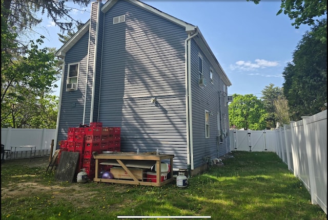 30 Mindres Ave, Brentwood, NY 11717 - exterior space with a chimney, a lawn, a gate, cooling unit, and a fenced backyard