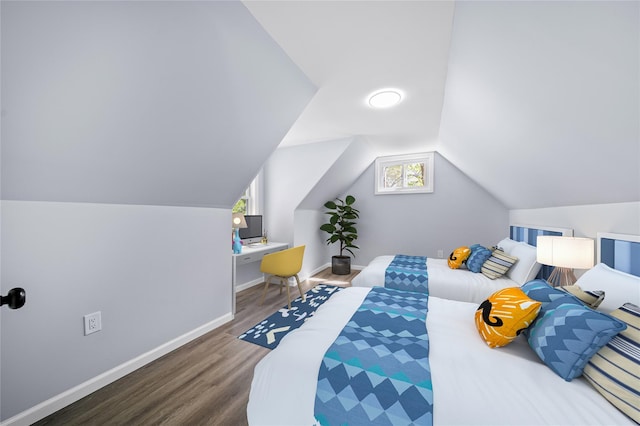 bedroom with baseboards, wood finished floors, and lofted ceiling