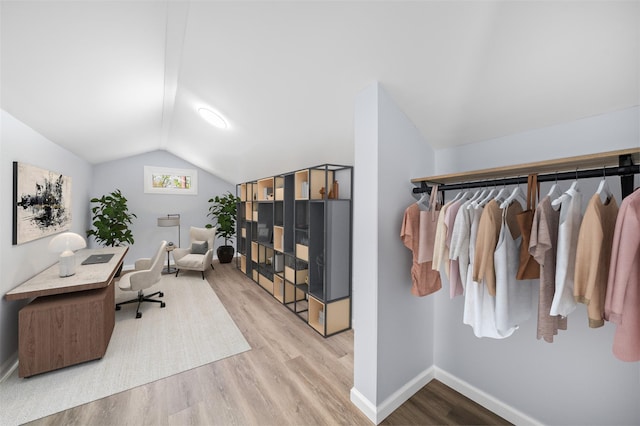 office area featuring baseboards, lofted ceiling, and wood finished floors