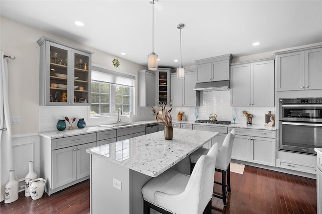 kitchen featuring glass insert cabinets, appliances with stainless steel finishes, and gray cabinets