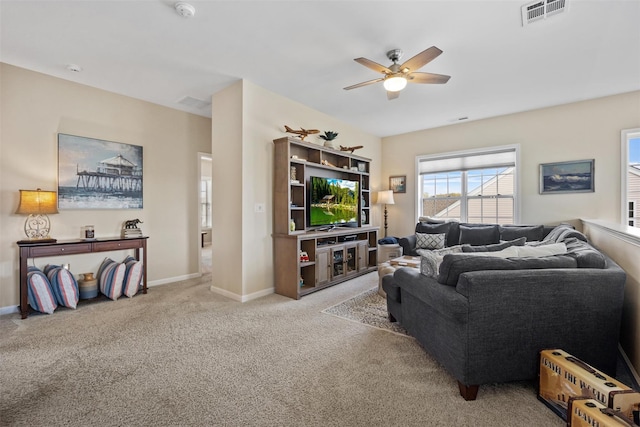 living room with visible vents, carpet, ceiling fan, and baseboards