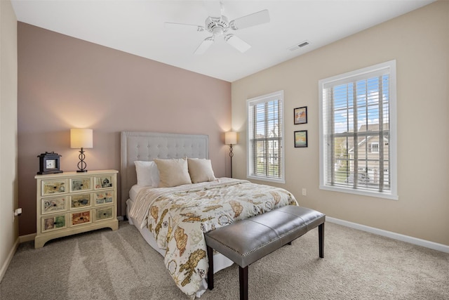 bedroom featuring baseboards, ceiling fan, carpet, and visible vents