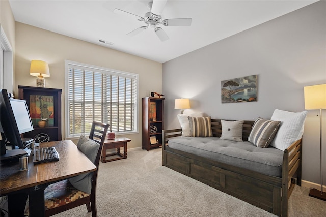 home office with a ceiling fan, baseboards, visible vents, and carpet