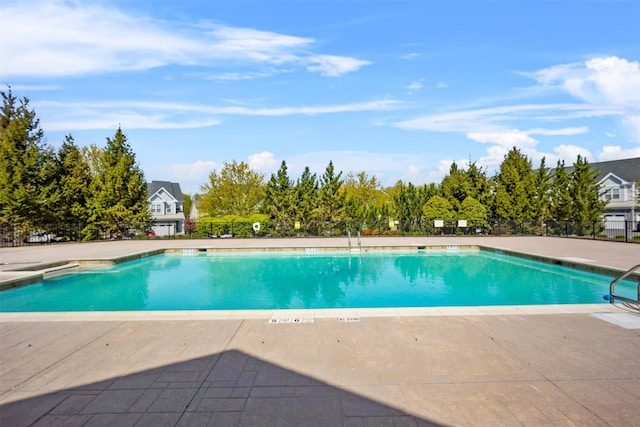 pool featuring a patio and fence