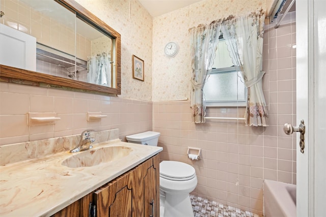 19 Winthrop St, New Hyde Park, NY 11040 - full bath featuring wallpapered walls, toilet, tile walls, wainscoting, and vanity