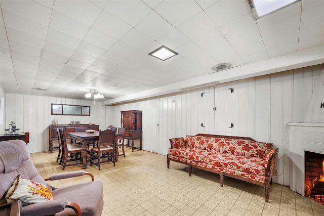 19 Winthrop St, New Hyde Park, NY 11040 - living room with light floors, a lit fireplace, and a decorative wall
