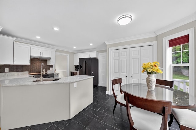 50 Roosevelt Dr, Poughquag, NY 12570 - kitchen with white cabinets, a peninsula, under cabinet range hood, crown molding, and decorative backsplash