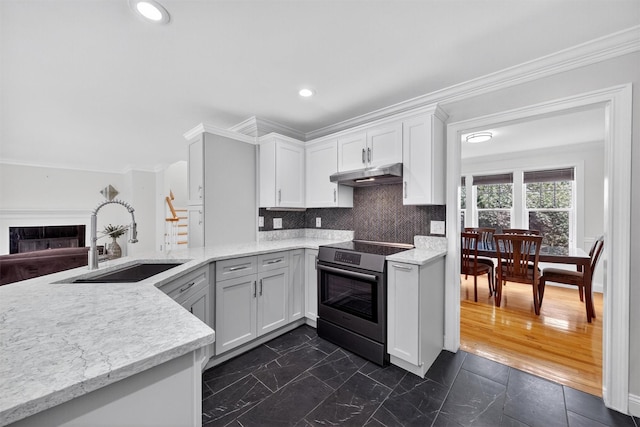 50 Roosevelt Dr, Poughquag, NY 12570 - kitchen featuring stainless steel range with electric stovetop, under cabinet range hood, crown molding, white cabinetry, and tasteful backsplash