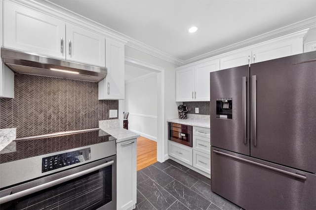 50 Roosevelt Dr, Poughquag, NY 12570 - kitchen with appliances with stainless steel finishes, under cabinet range hood, dark marble finish floors, white cabinetry, and tasteful backsplash