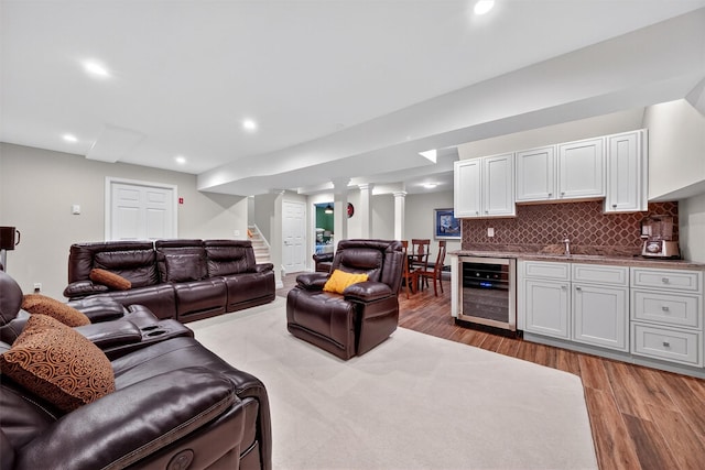 50 Roosevelt Dr, Poughquag, NY 12570 - living room with wine cooler, light wood-type flooring, bar with sink, recessed lighting, and stairway