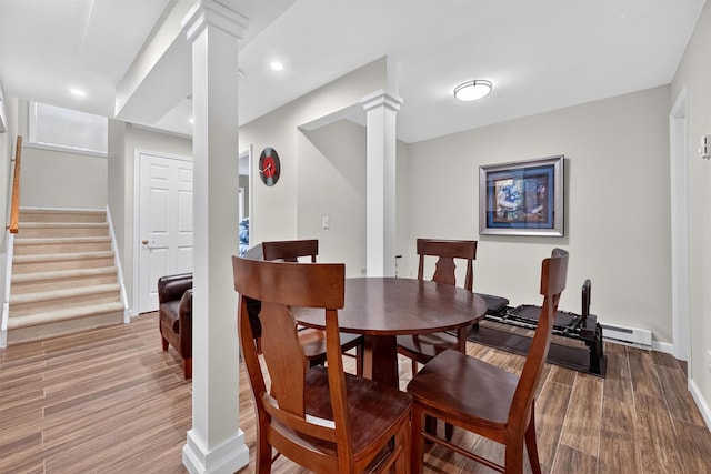 50 Roosevelt Dr, Poughquag, NY 12570 - dining room featuring ornate columns, wood finished floors, stairs, recessed lighting, and a baseboard radiator