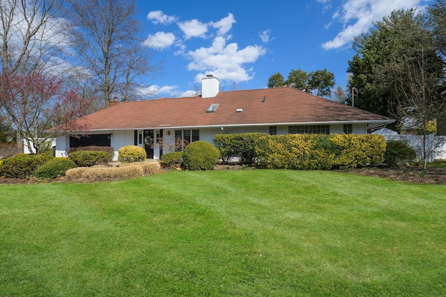 94 Schoolhouse Ln, Roslyn Heights, NY 11577 - rear view of house with a chimney and a yard