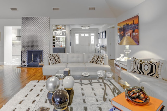 94 Schoolhouse Ln, Roslyn Heights, NY 11577 - living room with wood finished floors, a tile fireplace, and vaulted ceiling