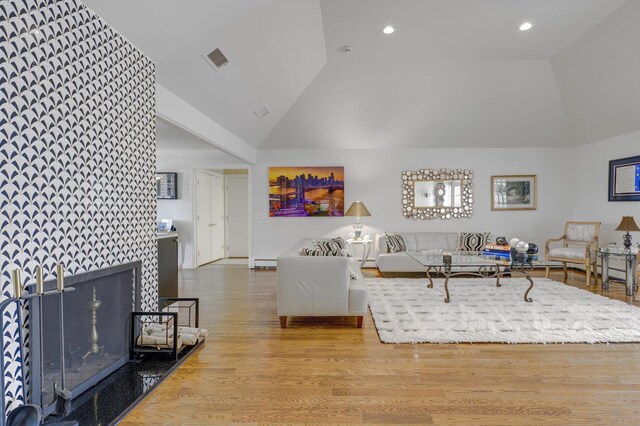 94 Schoolhouse Ln, Roslyn Heights, NY 11577 - living room with high vaulted ceiling, wood finished floors, recessed lighting, and baseboard heating