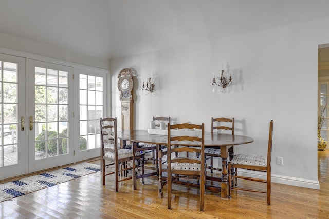 94 Schoolhouse Ln, Roslyn Heights, NY 11577 - dining space featuring french doors, wood finished floors, and baseboards