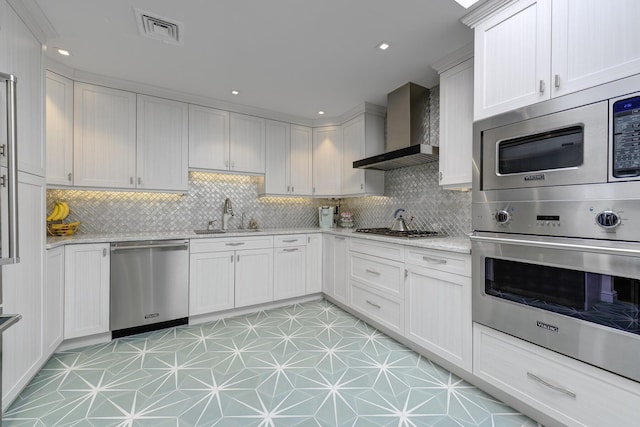 94 Schoolhouse Ln, Roslyn Heights, NY 11577 - kitchen with appliances with stainless steel finishes, wall chimney exhaust hood, a sink, tasteful backsplash, and recessed lighting