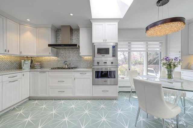 94 Schoolhouse Ln, Roslyn Heights, NY 11577 - kitchen featuring stainless steel appliances, wall chimney range hood, tasteful backsplash, and white cabinetry