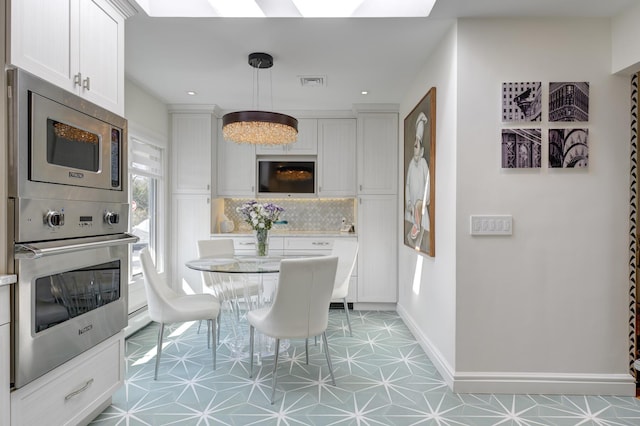 94 Schoolhouse Ln, Roslyn Heights, NY 11577 - dining room with a skylight, recessed lighting, and baseboards