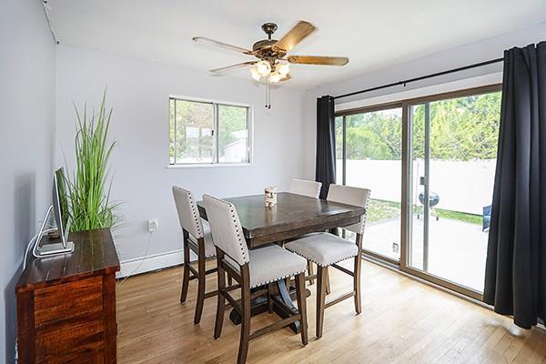 dining room with ceiling fan, baseboards, and light wood-type flooring