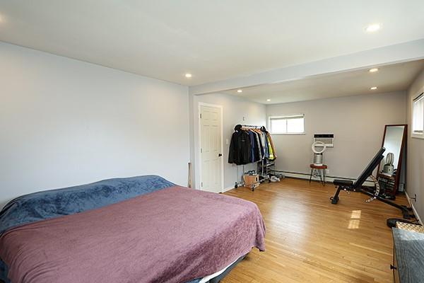 bedroom with light wood-style floors, baseboards, and recessed lighting
