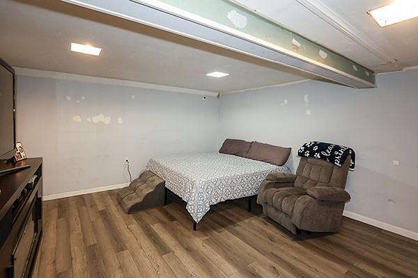 bedroom featuring baseboards and wood finished floors