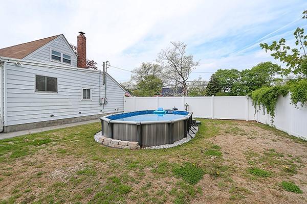 view of yard with a fenced in pool and a fenced backyard