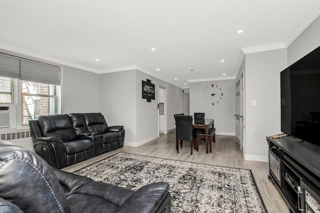 living area featuring light wood-type flooring, recessed lighting, baseboards, and crown molding