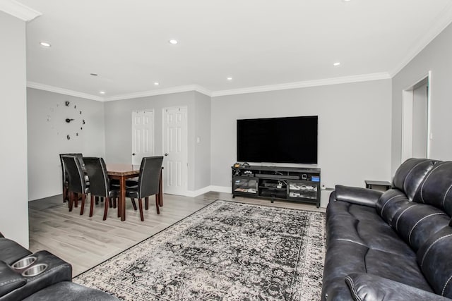 living area with wood finished floors, recessed lighting, crown molding, and baseboards