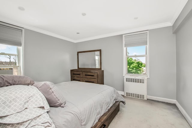 bedroom with radiator heating unit, baseboards, crown molding, and light colored carpet