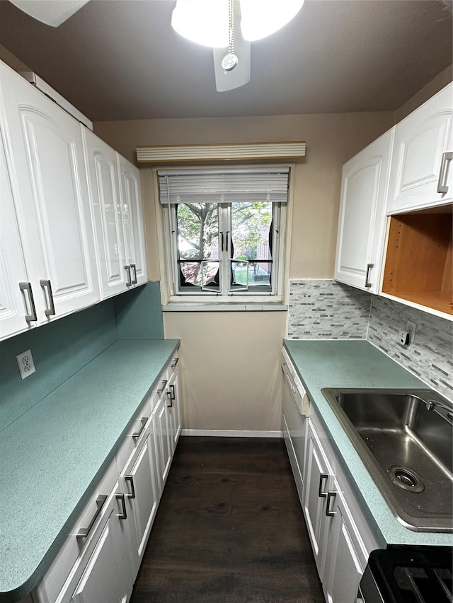 interior space with white cabinets, dark wood-style flooring, a sink, and dishwasher