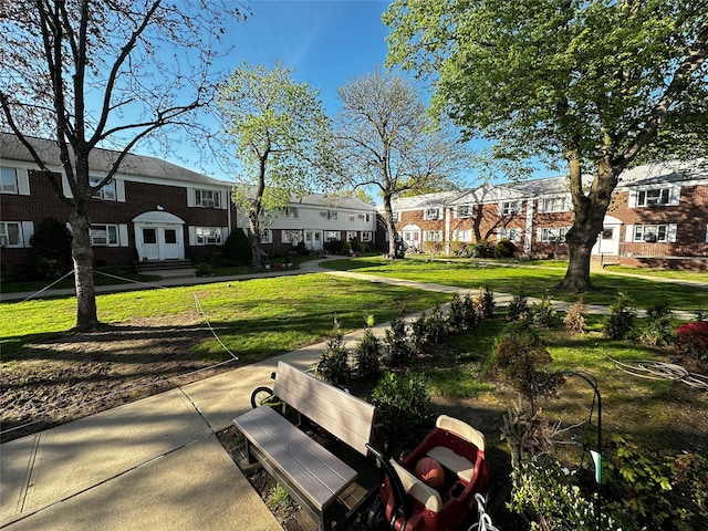 surrounding community featuring a yard and a residential view