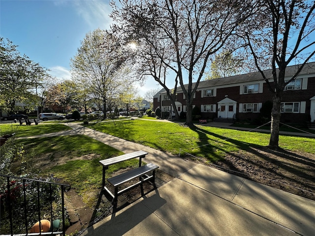 view of community with a residential view and a yard