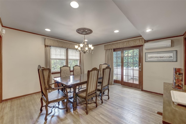 dining area with a wall mounted AC, baseboards, light wood-type flooring, crown molding, and a chandelier
