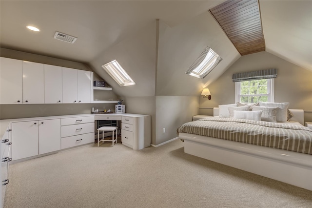 bedroom featuring lofted ceiling, light carpet, a skylight, and baseboards