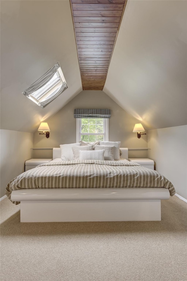 carpeted bedroom with baseboards and lofted ceiling