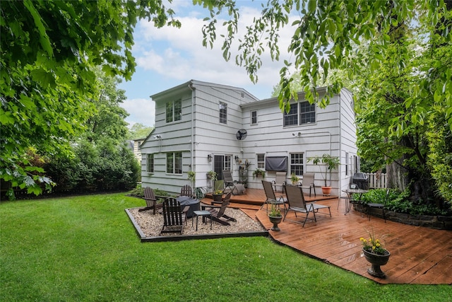 rear view of property with a lawn and a deck