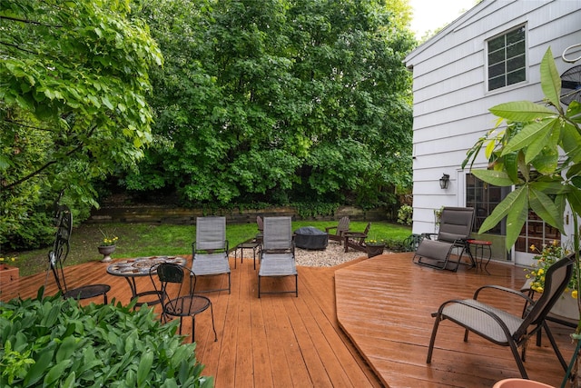 wooden terrace with a fire pit