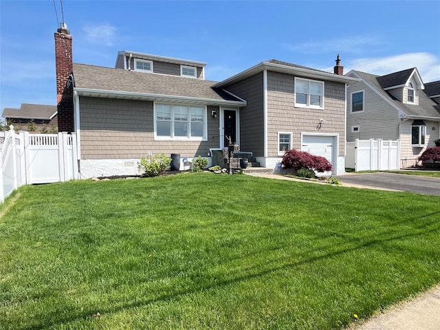 view of front of house with an attached garage, fence, driveway, and a chimney