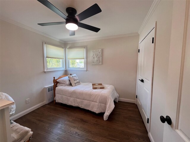 bedroom with baseboards, ornamental molding, radiator, and dark wood-type flooring