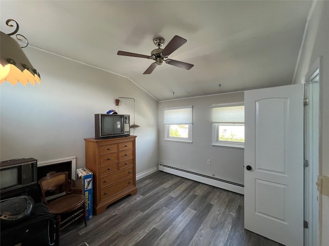 bedroom with a ceiling fan, a baseboard heating unit, dark wood-style floors, and vaulted ceiling
