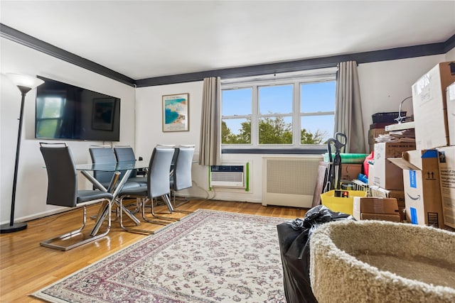 153-25 88th St Unit 3D, Howard Beach, NY 11414 - living area with radiator heating unit, wood finished floors, and a wall mounted air conditioner
