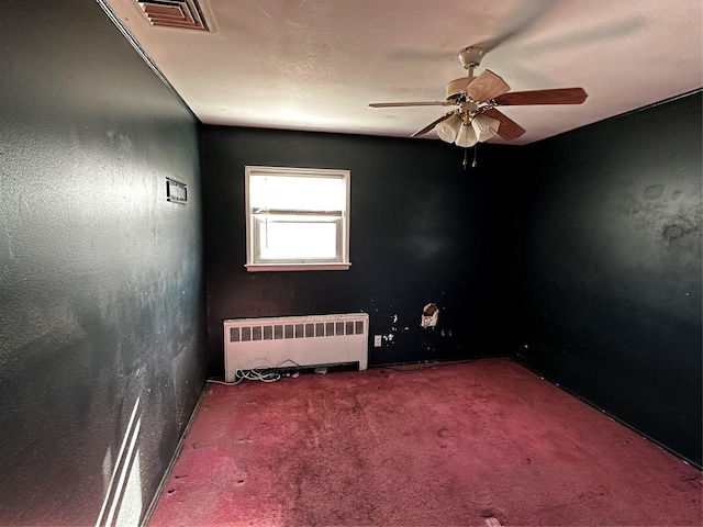 827 Eastfield Rd, Westbury, NY 11590 - unfurnished room featuring visible vents, carpet flooring, ceiling fan, and radiator heating unit