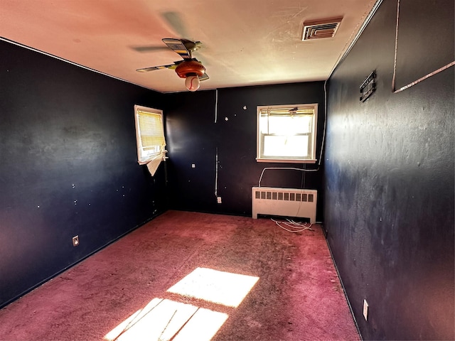 827 Eastfield Rd, Westbury, NY 11590 - carpeted empty room featuring radiator, ceiling fan, and visible vents