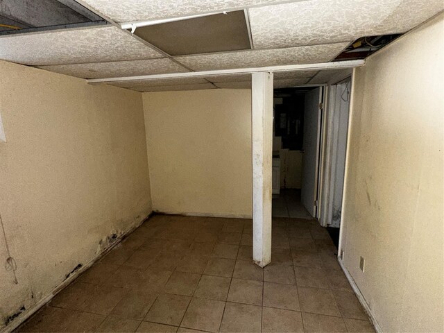 827 Eastfield Rd, Westbury, NY 11590 - finished below grade area with tile patterned floors and a paneled ceiling