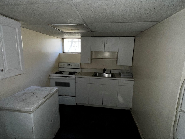 827 Eastfield Rd, Westbury, NY 11590 - kitchen with electric stove, a sink, white cabinetry, and light countertops