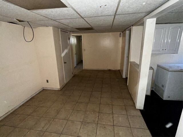 827 Eastfield Rd, Westbury, NY 11590 - interior space with baseboards, a drop ceiling, and light tile patterned floors
