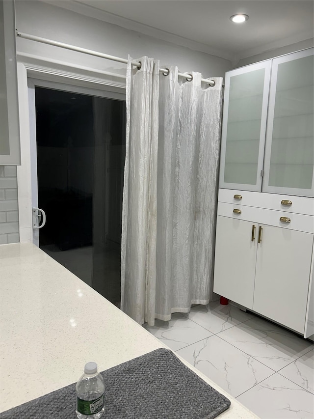 full bath featuring marble finish floors, recessed lighting, and curtained shower