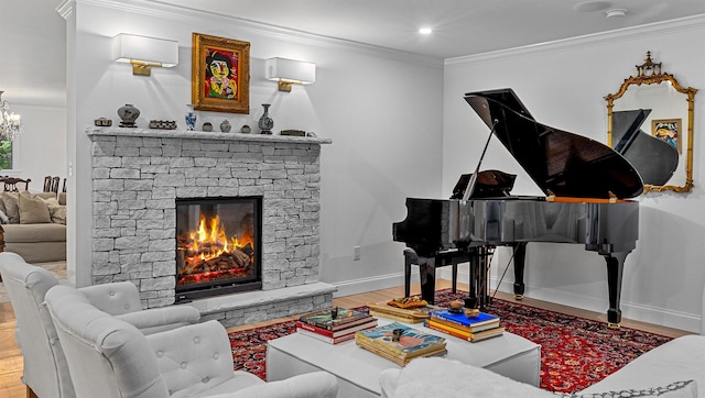 78 Schultz Hill Rd, Rhinebeck, NY 12580 - living room featuring crown molding, wood finished floors, baseboards, a chandelier, and a stone fireplace